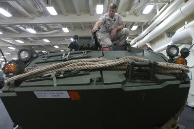 Lance Cpl. Jonathan S. Streit, a light armored vehicle crewman with 1st Light Armored Reconnaissance Battalion, 1st Marine Division, cleans the barrel of a 25mm bushmaster chaingun while part of Special Purpose Marine Air Ground Task Force ASEAN, aboard amphibious transport dock ship USS Anchorage (LPD-23), April 15, 2014. As part of SPMAGTF-ASEAN, 1st LAR showcased their territorial defense capabilities alongside units with 1st MLG on their mission to support the U.S. Secretary of Defense Chuck Hagel, during the Association of Southeast Asian Nations press conference in Hawaii, April 1-4, 2014. SPFMAGTF-ASEAN conducted further training at sea starting April 7, 2014. Streit is from Montrose, Colorado. (U.S. Marine Corps photo courtesy of Lance Cpl. Shaltiel Dominguez/ Released)