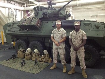 Sergeant Rolando Morales, left, chief scout with Alpha Company, 1st Light Armored Reconnaissance Battalion, 1st Marine Division, and Lance Cpl. Vladimir Charles, right, a scout with Alpha Co., 1st LAR, pose in front of a static display of equipment as part of Special Purpose Marine Air Ground Task Force ASEAN, aboard amphibious transport dock ship USS Anchorage (LPD-23), March 31, 2014. As part of SPMAGTF-ASEAN, 1st LAR showcased their territorial defense capabilities alongside units with 1st MLG on their mission to support the U.S. Secretary of Defense Chuck Hagel, during the Association of Southeast Asian Nations press conference in Hawaii, April 1-4, 2014. SPFMAGTF-ASEAN conducted further training at sea starting April 7, 2014.