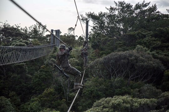 Marines traverse an obstacle during an endurance course April 17 at the Jungle Warfare Training Center on Camp Gonsalves. The endurance course is the culminating event of the weeklong basic jungle survival course. JWTC is the only facility of its type in the Department of Defense. The Marines are with various units assigned to Combat Assault Battalion, 3rd Marine Division, III Marine Expeditionary Force. (U.S. Marine Corps photo by Cpl. Stephen D. Himes/Released)