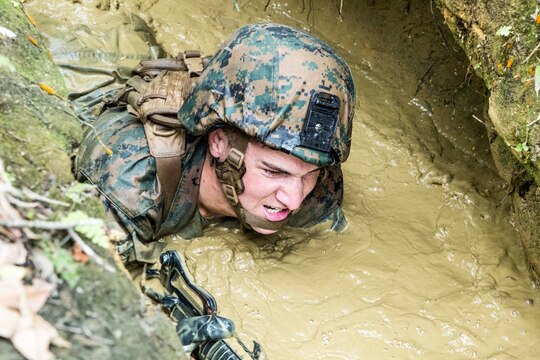 Lance Cpl. George Redhead, a native of San Jose, Calif., low crawls through the muddy water of the “pit-and-pond” section of the endurance course April 17 at the Jungle Warfare Training Center on Camp Gonsalves. The jungle is vastly different from the desert terrain many Marines have been training in for the past decade, according to Kao. The jungle does not allow for significant mechanized or motorized movements, which forces Marines to hone their dismounted warfighting abilities. Redhead is a rifleman with 3rd Light Armored Reconnaissance Battalion currently assigned to Combat Assault Battalion, 3rd Marine Division, III Marine Expeditionary Force, under the unit deployment program. Kao is a native of Vancouver, Wash., and is the camp commander for Camp Gonsalves, Marine Corps Base Camp Smedley D. Butler, Marine Corps Installations Pacific. (U.S. Marine Corps photo by Cpl. Stephen D. Himes/Released)