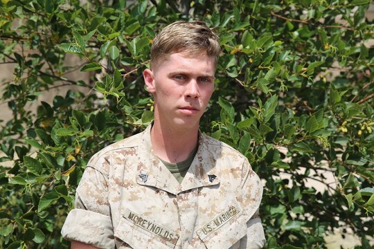 Corporal Clifton McReynolds, food service specialist, Headquarters Regiment, 1st Marine Logistics Group, poses for a photograph aboard Camp Pendleton, Calif., July 29, 2014. The 22-year old was not excited to be a food service specialist at first, but he found a passion for working with people and now thrives in a job which enables him to serve and converse with hundreds of Marines daily. 