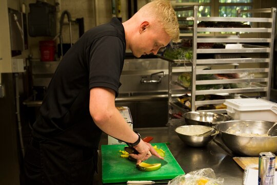 Cpl. Michael Haynes, member of the Marine Aide Program, prepares a food platter at Marine Barracks Washington, D.C., prior to the start of a Tuesday Sunset Parade, Aug. 4, 2014. (Official Marine Corps photo by Cpl. Dan Hosack/Released)