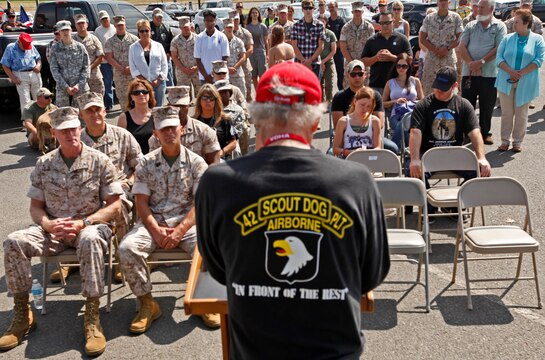 Joe Robinson, retired scout dog handler from the Vietnam era, read off the names of fallen military working dog handlers at a memorial in their honor at the Pacific Views Event Center's Memorial Garden here, Aug. 9.  The Dawgs Project, a company dedicated to military working dog handlers of all services, unveiled the memorial to commemorate all K-9 handling service members.