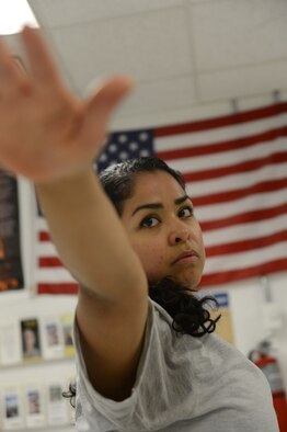 U.S. Air Force Senior Airman Kandie Ibarra, a native of Blackfoot, Idaho and a lab technician assigned to the 455th Medical Support Squadron, Craig Joint Theater Hospital, Bagram Airfield, Afghanistan moves into the warrior II pose during a yoga class June 23, 2014.  Ibarra leads a yoga class two nights a week and is deployed form Keesler Air Force Base, Miss. (U.S. Air Force photo by Master Sgt. Cohen A. Young/Released)
