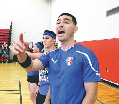 Chief Warrant Officer II Liam Rodriguez, personnel officer at Installation Personnel Administration Center, shouts from the sidelines after being knocked from the game during Headquarters and Service Battalion’s dodge ball tournament Aug. 14 at Barber Physical Activity Center.