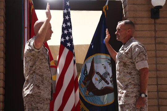 Lieutenant Gen. David H. Berger (left), commanding general, I Marine Expeditionary Force, and Brig. Gen. Vincent A. Coglianese (right), commanding general, 1st Marine Logistics Group, recite the Oath of Office during Coglianese's promotion to major general aboard Camp Pendleton, Calif., Aug. 19, 2014. Berger said Coglianese's selection to a two-star general position was a direct reflection of his ability to successfully lead in three particularly difficult billets during his time as a brigadier general.