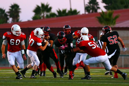 The Miramar Air Station Falcons claimed a 19-8 victory in their opening game of the season against the 1st Marine Division Headquarters Battalion Standard Bearers at the Paige Field House football field here, Aug. 26.  The night was a grueling contest starring two defenses that consistently forced fumbles throughout the night.

(Photo by; Cpl. Keenan Zelazoski)