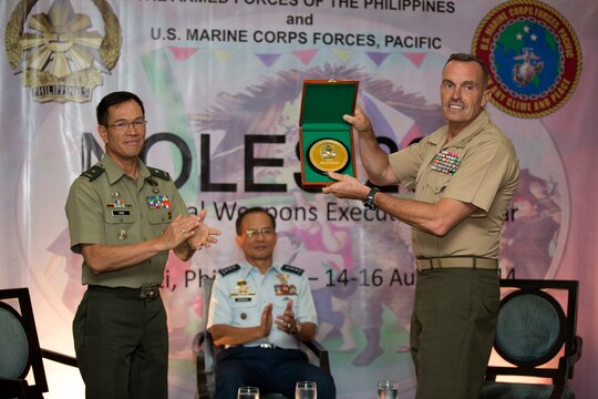 MAKATI CITY, Manila, Philippines – Philippine Brig. Gen. Arthur Ang, presents U.S. Marine Corps Brig. Gen. Vincent A. Coglianese, commanding general, 1st Marine Logistics Group with a gift of appreciation at the closing ceremony of Non-lethal Weapons Executive Seminar (NOLES) 2014, August 16. NOLES is an annual field-training exercise and leadership seminar sponsored by U.S. Marine Corps Forces Pacific, and hosted by various nations throughout the Asia-Pacific. This is the 13th iteration of NOLES with members from the AFP, and Philippine National Police participating. (U.S. Marine Corps photo by Cpl. Erik Estrada)