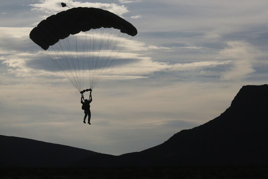 A U.S. Marine Critical Skills Operator with 1st Marine Special Operations Battalion, Marine Corps Forces, Special Operations Command, guides himself to a dropzone in the Arizona desert, during a double-bag static line (DBSL) parachute training course, Aug 25, 2014. The DBSL course was an introduction to the High Altitude, High Opening (HAHO) insertion method utilized by Special Operations Forces. (U.S. Marine Corps Photo by Lance Cpl. Steven M. Fox/Released)