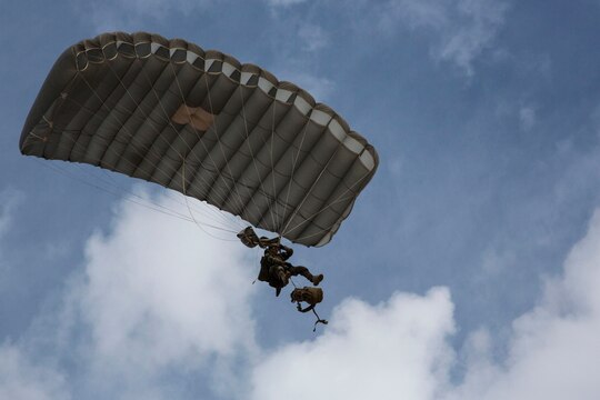 A U.S. Marine Critical Skills Operator with 1st Marine Special Operations Battalion, Marine Corps Forces, Special Operations Command, releases his ruck sack from his body, preparing to land during a double-bag static line (DBSL) parachute training course , Aug 26, 2014, in rural Arizona. The DBSL course was an introduction to the High Altitude, High Opening (HAHO) insertion method utilized by Special Operations Forces. (U.S. Marine Corps Photo by Lance Cpl. Steven M. Fox/Released)