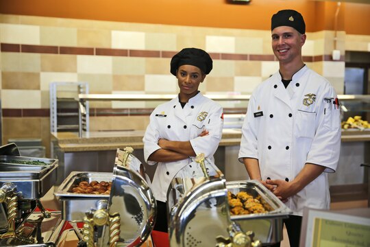 Marines with Marine Headquarters Group, I Marine Expeditionary Force, pose for a photograph during the Chef of the Quarter culinary competition here, Dec. 3. The competition began with twelve teams that took verbal and written quizzes, testing their culinary knowledge and proficiency. The top four teams were then assigned three proteins and fresh ingredients to prepare a high-quality menu to use for the cook-off stage. 