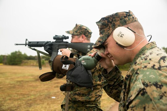Gunnery Sgt. Jason Hunt, the Marine Corps Air Station Beaufort shooting team coach, looks through a spotting scope for Chief Warrant Officer 2 Jason Harrington, a MCAS Beaufort shooting team member, Nov. 24, 2014, on Parris Island, S.C. Spotting scopes provide a closer look at the target so coaches can better help their shooters. Parris Island’s annual rifle and pistol tournament is held to foster competitiveness and enhance combat readiness. Hunt, 36, is from Cedar Rapids, Iowa. Harrington, 32, is from Cobleskill, N.Y. (Photo by Cpl. Jennifer Schubert)