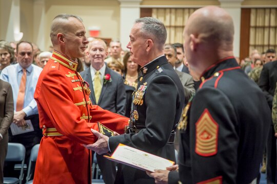 The 36th Commandant of the Marine Corps, Gen. Joseph F. Dunford, retires Maj. Brian Dix, outgoing commanding officer of "The Commandant's Own," The United States Marine Drum & Bugle Corps, during a retirement and change of command ceremony at Marine Barracks Washington, D.C., on Dec. 11, 2014.