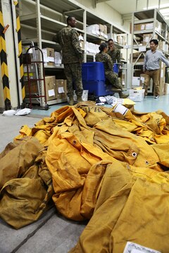 Marines at the Mainside Postal Office aboard Marine Corps Air Station Iwakuni, Japan, organize, sort and clear the flooded mailroom, Dec. 11, 2014. More than 700 pounds of mail are sent per day and 3,500 pounds of mail are received per day during the busy holiday season months of late November to mid-January.