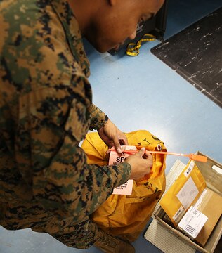 Marines at the Mainside Postal Office aboard Marine Corps Air Station Iwakuni, Japan, continue to push through the demanding overload of mail during the busiest time of the year. More than 700 pounds of mail are sent per day and 3,500 pounds of mail are received per day during the busy holiday season months of late November to mid-January.