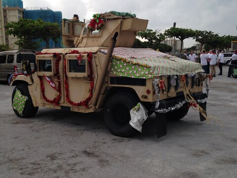 A Humvee is decorated as a float with Christmas ornaments and stockings during the 2014 Camp Kinser Tree Lighting Ceremony and Holiday parade November 28 here. Approximately 300 service members, families and Okinawa community members watched a parade of military vehicles dressed as Christmas floats. The event included several performances, such as taiko drummers and hula dancers. A Christmas tree was lit to mark the end of the event.