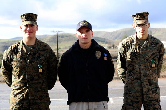 CAMP PENDLETON, Calif. -- Sgt. Daniel E. Norris, Officer Russell Palmeri and Cpl. Lance F. Bryant were presented with the Navy and Marine Corps Commendation Medal for meritorious service and the Navy Meritorious Civilian Service award, for heroic actions that saved the life of a Marine, at the Military Police Department headquarters building here, Dec. 17. 

Norris and Bryant are military police patrolmen and Palmeri is a civilian police officer with the Marine Corps Police Department, Security and Emergency Services Battalion here.

(Lance Cpl. Asia J. Sorenson)
