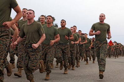 Marines with Combat Logistics Regiment 15 complete a boots and utilities formation run to the Las Pulgas football field aboard Camp Pendleton as part of a physical training session, Jan. 24, 2014. In addition to the formation run, the Marines faced off in a pugil-stick match over three feet of water and competed in body jousting, an event in which Marines raced across a wet and soapy tarp with unit-decorated refrigerator boxes over their heads. The winner of the overall physical fitness competition was Maintenance Battalion.
