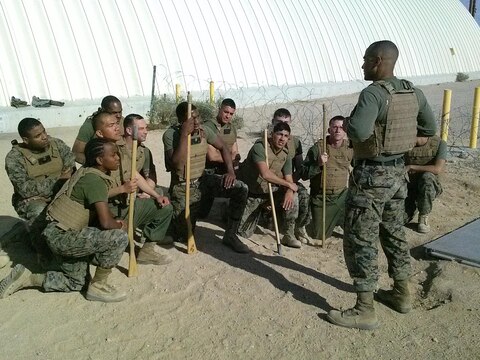 Sgt. Ryan-Michael Daffin, an avionic technician with Marine Light Attack Helicopter Squadron (HMLA) 267, mentors his Marine Corps Martial Arts Program students after a session aboard Marine Corps Air-Ground Combat Center Twentynine Palms, Calif., Jan. 28. Daffin taught his Marines a variety of classes ranging from combat readiness to financial readiness during his MCMAP sessions.