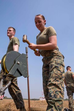 Pfc. Meagan Quinn hammers a grounding reel near a fueling point for a Tactical Airfield Fuel Dispensing System aboard Wing One Royal Thai Air Force Base, Nakhon Ratchasima, Kingdom of Thailand, Feb. 2 in preparation for exercise Cobra Gold 2014. CG 14 is a joint, multinational exercise conducted annually in the Kingdom of Thailand aimed increasing readiness and interoperability of the Thai, U.S. and other fully participating military forces. Quinn is a bulk fuels specialist with Marine Wing Support Squadron 171, Marine Aircraft Group 12, 1st Marine Aircraft Group, III Marine Expeditionary Force. 