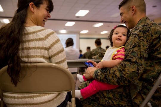 Cpl. Luis Urquijo and Cpl. Cythnia Urquijo, react to their daughter’s laughter during a “P.S., before you say I do” seminar at the Blinder Memorial Chapel, Feb. 19. The Naval Hospital Camp Pendleton hosted the seminar to educate Marines, sailors and their significant others about potential stressors and difficulties that could arise during the early stages of marriage. Luis and Cythnia are administrative clerks with Headquarters and Support Battalion.