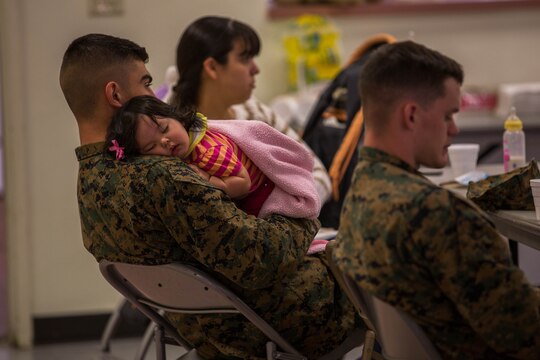 Cpl. Luis Urquijo soothes his daughter to sleep during a “P.S., before you say I do” seminar at the Blinder Memorial Chapel, Feb. 19. The Naval Hospital Camp Pendleton hosted the seminar to educate Marines, sailors and their significant others about potential stressors and difficulties that could arise during the early stages of marriage. Urquijo is an administrative clerk with Headquarters and Support Battalion.