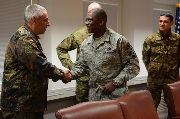 Chief Master Sgt. James Davis greets Chief Master Sgt. Rolf during a visit to USAFE-AFAFRICA Headquarters Feb. 18, 2014, at Ramstein Air Base, Germany. Gemünden was joined by nine other NCOs from eight nations for an office call with Davis as part of the Kaiserslautern Military Community First Sergeant Council's Additional Duty First Sergeant Symposium.  Davis is the U.S. Air Forces in Europe and Air Forces Africa command chief master sergeant and Gemünden is an instructor and advisor with the German air force's Non-Commissioned Officer Academy. (U.S. Air Force Photo/Tech. Sgt. James M. Hodgman) 
