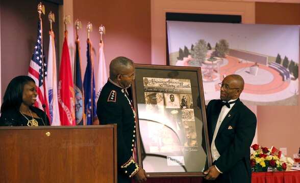 Lt. Gen. Ronald L. Bailey receives a gift during the Montford Point Marine Association’s 26th annual Heritage Dinner Dance at the Marston Pavilion aboard Marine Corps Base Camp Lejeune, Feb. 22. Bailey served as the guest speaker for the event. 