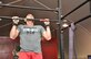 Air Force Capt. Sam Murray, 380th Expeditionary Security Forces Squadron operations officer in charge, does a pull up before a class at the tactical fitness facility at an undisclosed location in Southwest Asia, Jan. 3, 2014. (U.S. Air Force photo by Maj. Khalid Cannon/Released)