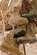 Over 200 pairs of boots hang from the ceiling of an old, damaged building at an undisclosed location in Southwest Asia.  The boots are part of a tradition that Airmen in the fuels career field started more than 20 years ago.  The fuels Airmen believe that if you discard an old pair of boots according to a specific ritual, you will not be tasked to return to the same location in the future.  (U.S. Air Force photo by Senior Master Sgt. Burke Baker)
