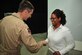 Air Force Brig. Gen. Kevin Schneider, 380th Air Expeditionary Wing commander, thanks Aungelic Nelson, 380 AEW historian, for her service to the 380 AEW at an undisclosed location in Southwest Asia, Jan. 7, 2014. (U.S. Air Force photo by Staff Sgt. Michael Means/Released)