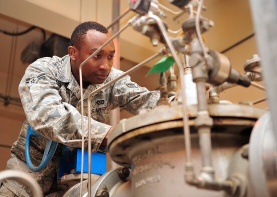 Air Force Airman 1st Class Kevin Yator, a utilities journeyman assigned to the 380th Expeditionary Civil Engineer Squadron troubleshoots an automatic valve for an aircraft fueling system. (U.S. Air Force photo by Staff Sgt. Michael Means/Released)