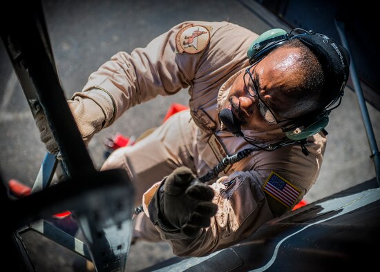 Airman 1st Class Darhon Hambrick, 22nd Expeditionary Air Refueling Squadron in-flight refueling specialist, climbs up a KC-135 Stratotanker crew ladder at the Transit Center at Manas, Kyrgyzstan, to start the pre-flight checks of the aircraft before a refueling mission over Afghanistan, Jan. 17, 2014. Hambrick is deployed from MacDill Air Force Base, Fla., and is a native of Nashville, Tenn. (U.S. Air Force photo/Staff Sgt. Travis Edwards)
