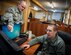 Tech. Sgt. Jeff Thorpe, 376th ECS NCO in charge of the help desk, discusses a recent trouble ticket with Airman 1st Class Josh Allen, 376th ECS help desk technician Jan. 10, 2013, at the Transit Center at Manas, Kyrgyzstan.  Thorpe and Allen are part of team of five Airmen who manage the working condition of nearly 7,500 computers on the TCM. Thorpe and Allen are both deployed from MacDill AFB, Fla. Thorpe is a native of Charles Town, W.V., and Allen is from York, Penn. (U.S. Air Force photo/Staff Sgt. Travis Edwards)
