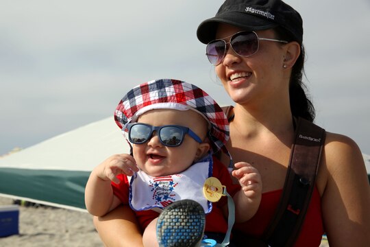 Briana Biggerstaff and son Breyden, 6 months, walk out toward the water while at the Beach Bash at Del Mar Beach here July 4.  

The Beach Bash is an on-base event open to service members, dependents and guests and features live bands, kids’ activities, a tribute to heroes video, a fireworks show and give-aways.