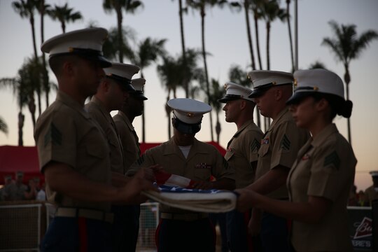 MARINE CORPS AIR STATION MIRAMAR, Calif. – Noncommissioned officers with Marine Aircraft Group (MAG) 16 fold an American flag at the end of a colors ceremony aboard Marine Corps Air Station Miramar, Calif., July 7. Marine Corps Community Services organized a live performance by Gary Sinise and the Lt. Dan Band for service members and families aboard the air station along with the colors ceremony run by the MAG-16 NCOs. 