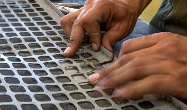 A CH-53E Super Stallion airframe mechanic with Marine Heavy Helicopter Squadron (HMH) 462, works on patching a mixing unit access screen panel for a Super Stallion aboard Marine Corps Air Station Miramar, Calif., July 10. Before a helicopter airframe mechanic can even touch an aircraft, he or she attends schooling in Naval Air Station Pensacola, Fla., where students learn the very basics of their occupational specialties. 