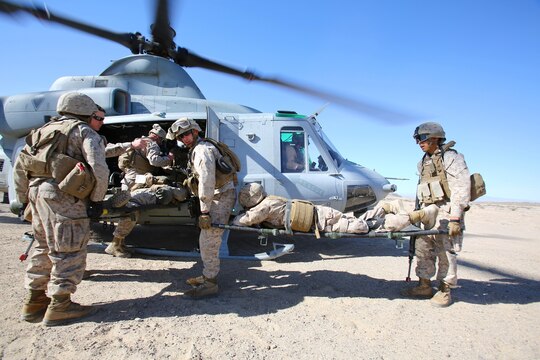 Marines and sailors with Combat Logistics Battalion 1, Combat Logistics Regiment 1, 1st Marine Logistics Group, evacuate a simulated casualty into a UH-1Y Huey during a Marine Readiness Exercise aboard Marine Corps Air Ground Combat Center Twenty-nine Palms, Calif., March 26, 2014. The MRX is part of the month-long Integrated Training Exercise 3-14 that prepares the battalion for its role as the logistics combat element in the final combat deployment of Operation Enduring Freedom. 