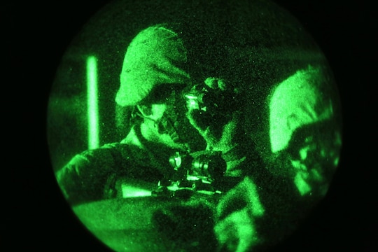A Marine from Combat Logistics Battalion 1, Combat Logistics Regiment 1, 1st Marine Logistics Group, uses a night vision optic while on guard during the Marine Readiness Exercise aboard Marine Corps Air Ground Combat Center Twenty-nine Palms, Calif., March 25, 2014. The MRX is part of the month-long Integrated Training Exercise 3-14 that prepares the battalion for its role as the logistics combat element in the final combat deployment in support of Operation Enduring Freedom.