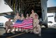 Aircrew from the 737th Expeditionary Airlift Squadron pose behind a C-130H Hercules after a day of flying July 20, 2014 at an undisclosed location in Southwest Asia. The crew just finished a mission transporting personnel and equipment to two locations in area of responsibility. The entire crew deployed here together from the 910th Airlift Wing, Youngstown Air Reserve Station, Ohio in support of Operation Enduring Freedom. (U.S. Air Force photo by Staff Sgt. Jeremy Bowcock)