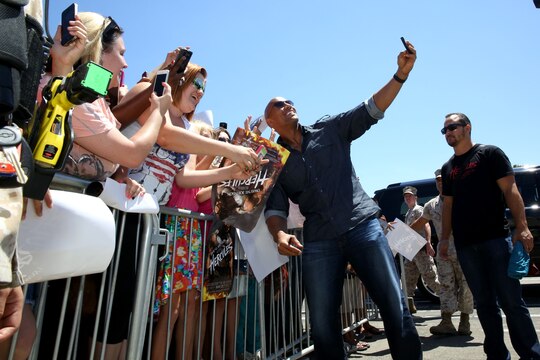 Actor Dwayne "The Rock" Johnson took selfies with fans and signed autographs before the screening of his new movie "Hercules" at the base theater here July 24.

Some fans lined up as early as 3 a.m. at the theater to meet the actor.