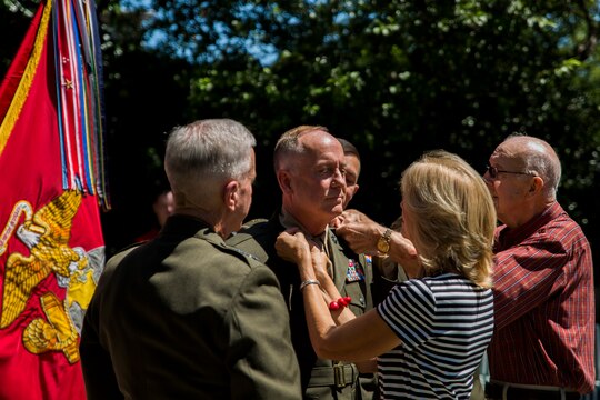 Rear Adm. Brent Scott, chaplain of the Marine Corps, has his rank insignia pinned on by his family during a ceremony at Marine Barracks Washington, D.C., July 25, 2014. Scott is the 19th chaplain of the Marine Corps. (Official Marine Corps photo by Cpl. Dan Hosack/Released)