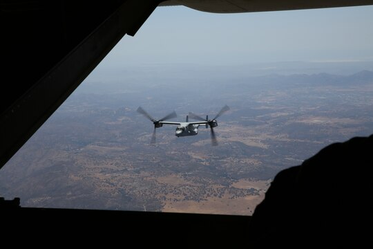 An MV-22B Osprey with Marine Medium Tiltrotor Squadron (VMM) 166 flies alongside another Osprey during a training exercise from Marine Corps Air Station Miramar, Calif., July 24. The flight included confined-area landing and tactical formations. 