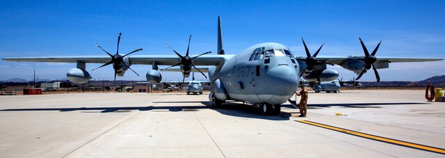 Sgt. Carl Kilpatrick, crew master with Marine Aerial Refueler Transport Squadron (VMGR) 352 “Raiders,” attaches a ground wire to a KC-130J Hercules after completing low-level tactical navigation training outside of Yuma, Ariz., July 24. During the training, the Raiders fly low and use terrain such as mountains, hills, valleys or trees to simulate evading detection by enemy radar systems.