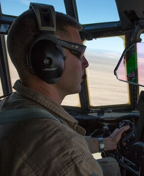 Capt. Luke Roberts, a flight commander with Marine Aerial Refueler Transport Squadron (VMGR) 352 “Raiders,” guides his co-pilot during low-level tactical navigation training with a KC-130J Hercules outside of Yuma, Ariz., July 24. Flight commanders teach pilots and ensure they are mission ready.