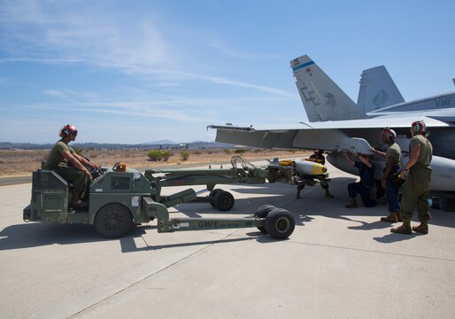 Aviation ordnance Marine with Marine All-Weather Fighter Attack Squadron (VMFA(AW)) 225 “Vikings” prepare to load a MK-82 low-drag bomb on an F/A-18 Hornet during high-explosive ordnance loading training at the combat aircraft loading area aboard Marine Corps Air Station Miramar, Calif., July 29. These Marines are also responsible for conducting system checks on all the aircraft before loading ordnance.