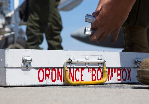 An aviation ordnance Marine with Marine All-Weather Fighter Attack Squadron (VMFA(AW)) 225 “Vikings” grabs cartridge-actuated devices during high-explosive ordnance loading training at the combat aircraft loading area aboard Marine Corps Air Station Miramar, Calif., July 29. Ordnance Marines in the squadron conduct this training to hone their skills of loading LAU-10 rockets and MK-82 low-drag bombs on F/A-18 Hornets.  