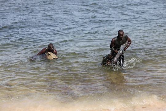 Two Senegalese Commandos from the Compagnie Fusilier de Marine Commandos, or COFUMACO, assault a beachhead in Dakar, Senegal, May 22, 2014. A group of U.S. Marines from Special-Purpose Marine Air-Ground Task Force Africa 14, from 3rd Battalion, 8th Marine Regiment, partnered with the COFUMACO to enable a cadre of their own to conduct training in infantry and amphibious tactics for the rest of their company.