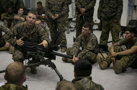 Staff Sgt. Eric J. Ellenberger, left, teaches the fundamentals of the MK19 40 mm automatic grenade launcher June 5 on Camp Mujuk, South Korea. The U.S. Marines familiarized themselves with the crew served weapon to enhance safety on ranges where they will train Republic of Korea Marines on the weapons employment as part of Korean Marine Exchange Program 14-8. KMEP 14-8 is one iteration in a series of continuous combined training exercises designed to enhance the ROK-U.S. alliance, promote stability on the Korean Peninsula, and strengthen ROK-U.S. military capabilities and interoperability. Ellenberger is a military policeman with 3rd Law Enforcement Battalion, III Marine Expeditionary Force Headquarters Group, III MEF. (U.S. Marine Corps photo by Lance Cpl. Drew Tech/Released)