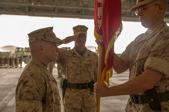 Lt. Col. Howard Eyth, right, passes the Marine Wing Support Squadron 171 colors to Lt. Col. James Whiteker during a change-of-command ceremony, June 9, 2014, at Hangar 6030 aboard Marine Corps Air Station Iwakuni, Japan. The passing of colors signifies the passing of command from one commanding officer to another. 